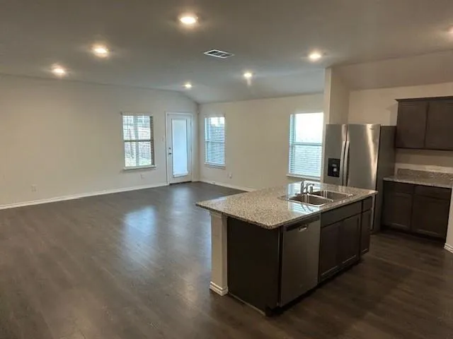 a kitchen with stainless steel appliances granite countertop a stove and a refrigerator