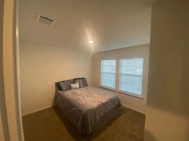 a bedroom with a bed and window