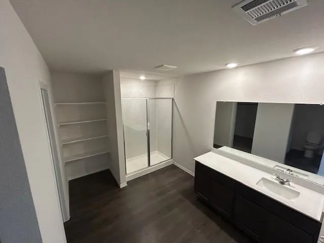 a bathroom with a double vanity sink and a mirror
