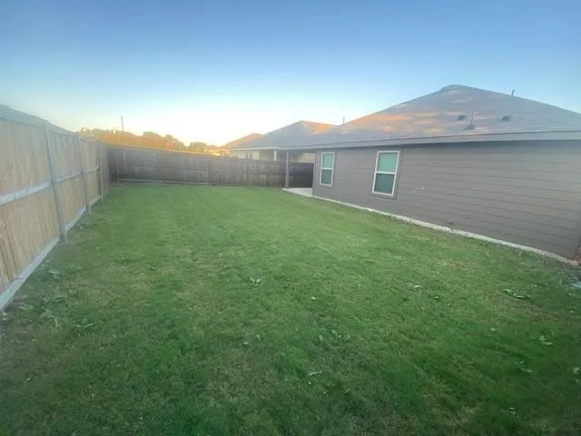 a view of a house with a backyard
