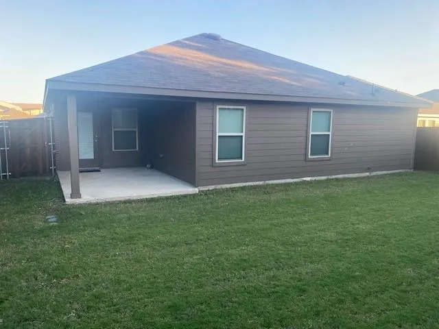 a view of house with backyard