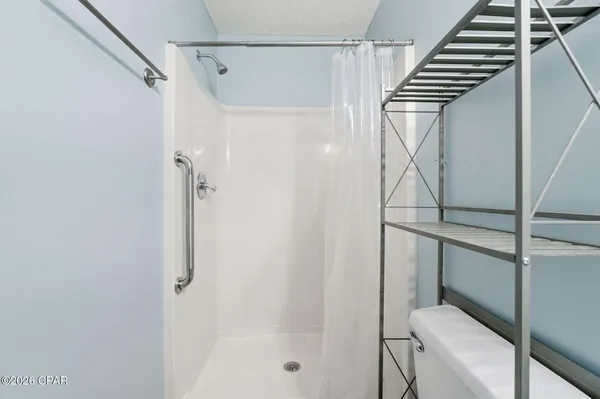 a bathroom with a shower and toilet