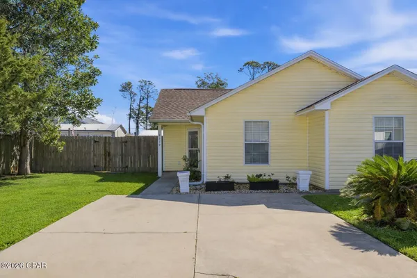 a backyard of a house with plants and trees