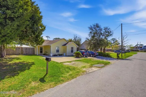 a view of a house with backyard and sitting area
