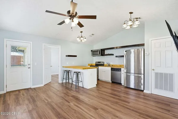 a view of kitchen with furniture and wooden floor
