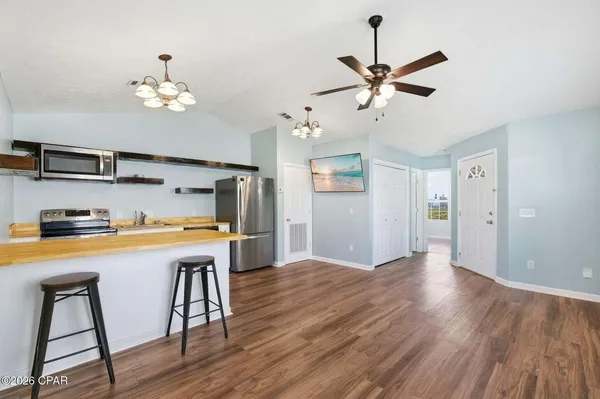 a view of a kitchen with a table and chairs
