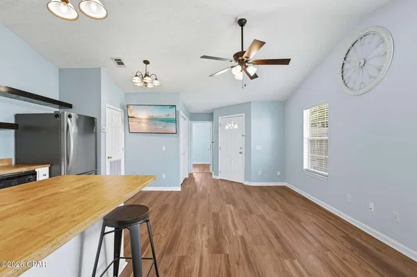 a view of a room with wooden floor and window