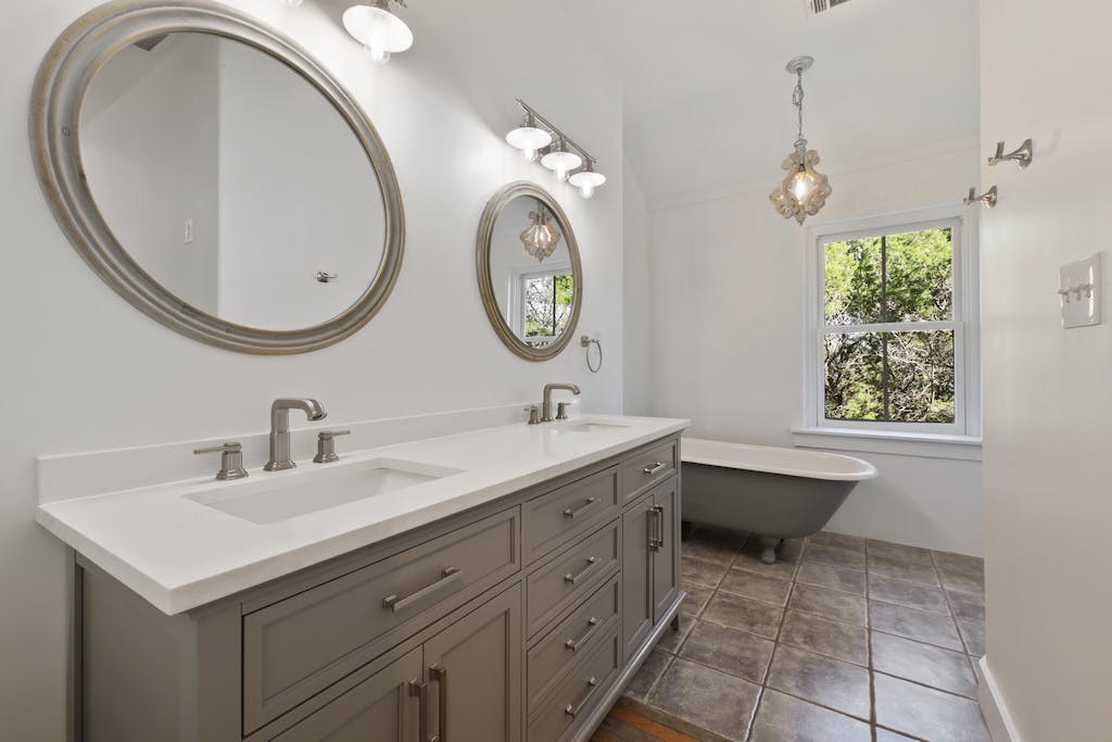 1612 The High Road Austin, TX 78746 - Photo 19 of 26 a bathroom with a sink and a mirror