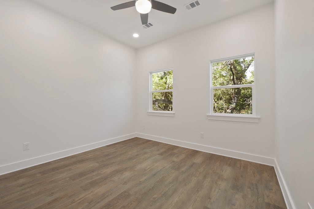 1612 The High Road Austin, TX 78746 - Photo 20 of 26 wooden floor in an empty room with a window