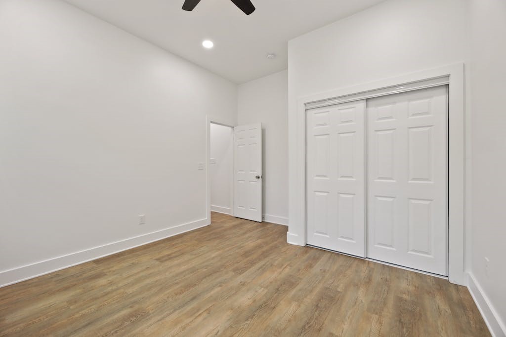 1612 The High Road Austin, TX 78746 - Photo 21 of 26 a view of an empty room with wooden floor