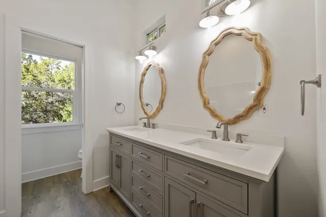 a bathroom with a tub sink and mirror