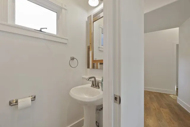 a bathroom with a toilet a sink and a mirror