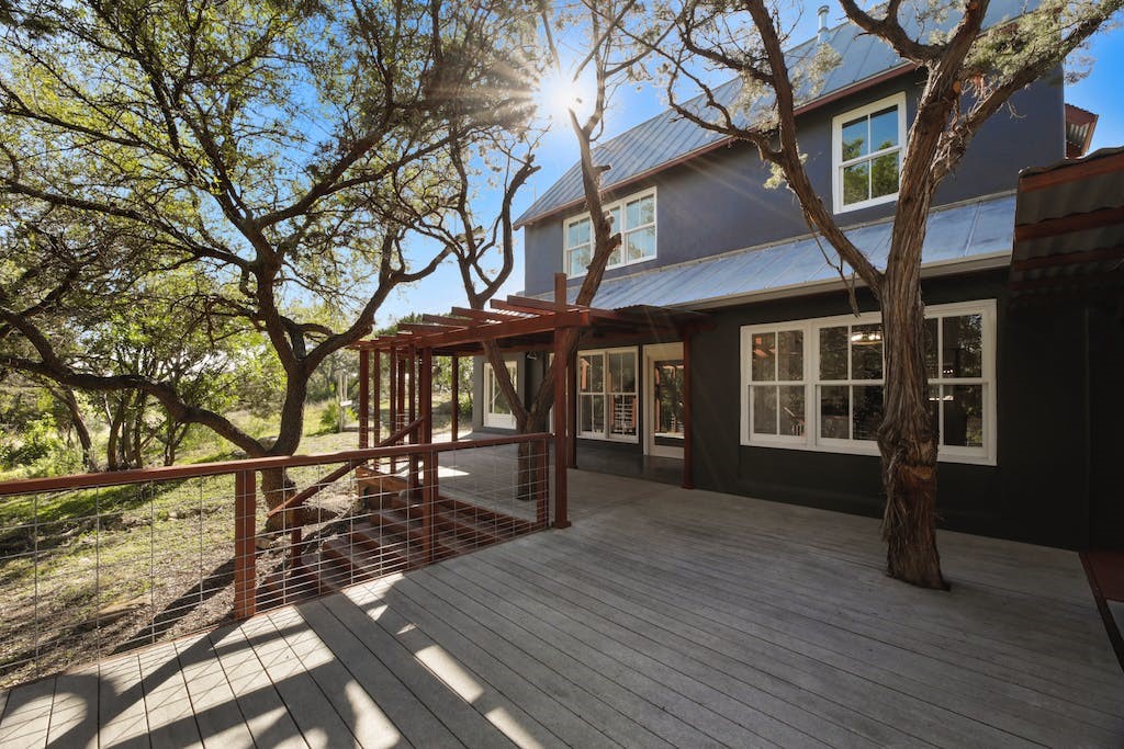 1612 The High Road Austin, TX 78746 - Photo 4 of 26 a front view of a house with a yard