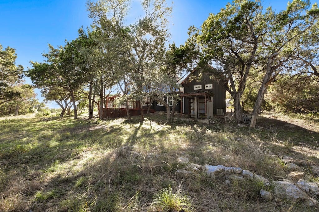 1612 The High Road Austin, TX 78746 - Photo 6 of 26 a view of house with a yard