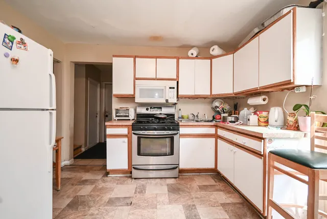 a kitchen with stainless steel appliances granite countertop a refrigerator sink and cabinets