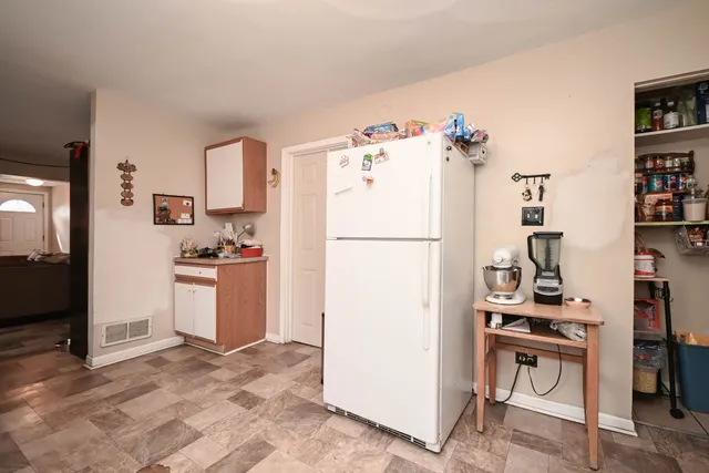 a kitchen with a refrigerator and a stove