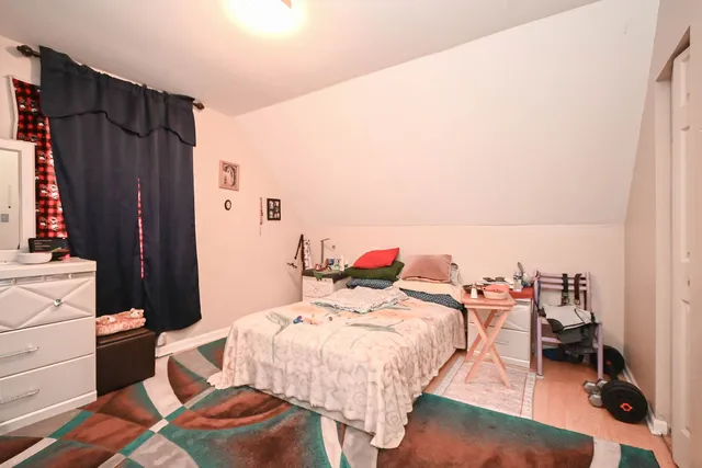 a bed room with a bed and a chair