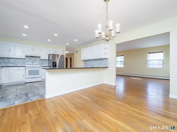 a view of kitchen with granite countertop cabinets and wooden floor