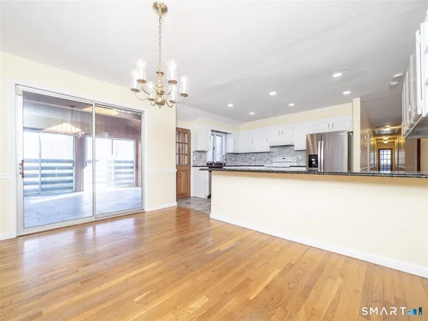 a view of a kitchen with wooden floor and a kitchen