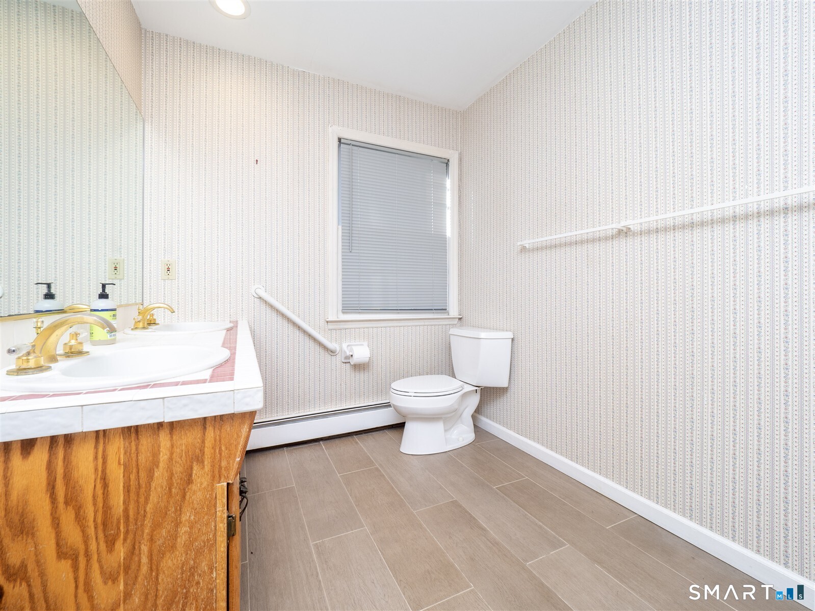 267 Thayer Pond Road Wilton, CT 06897 - Photo 18 of 28 a bathroom with a sink a toilet and mirror