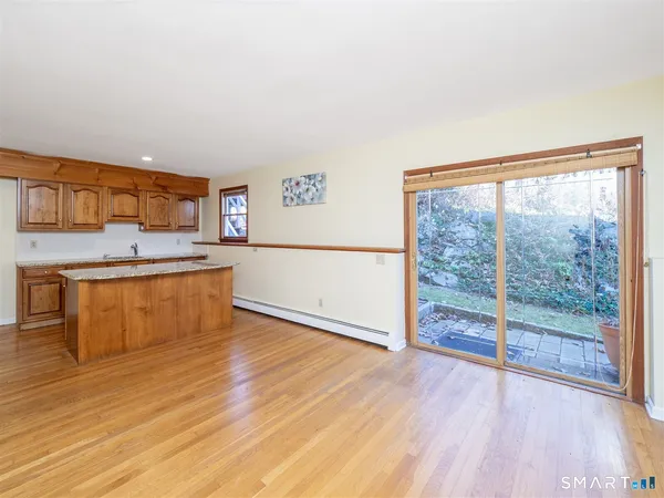 a view of a kitchen with wooden floor and electronic appliances