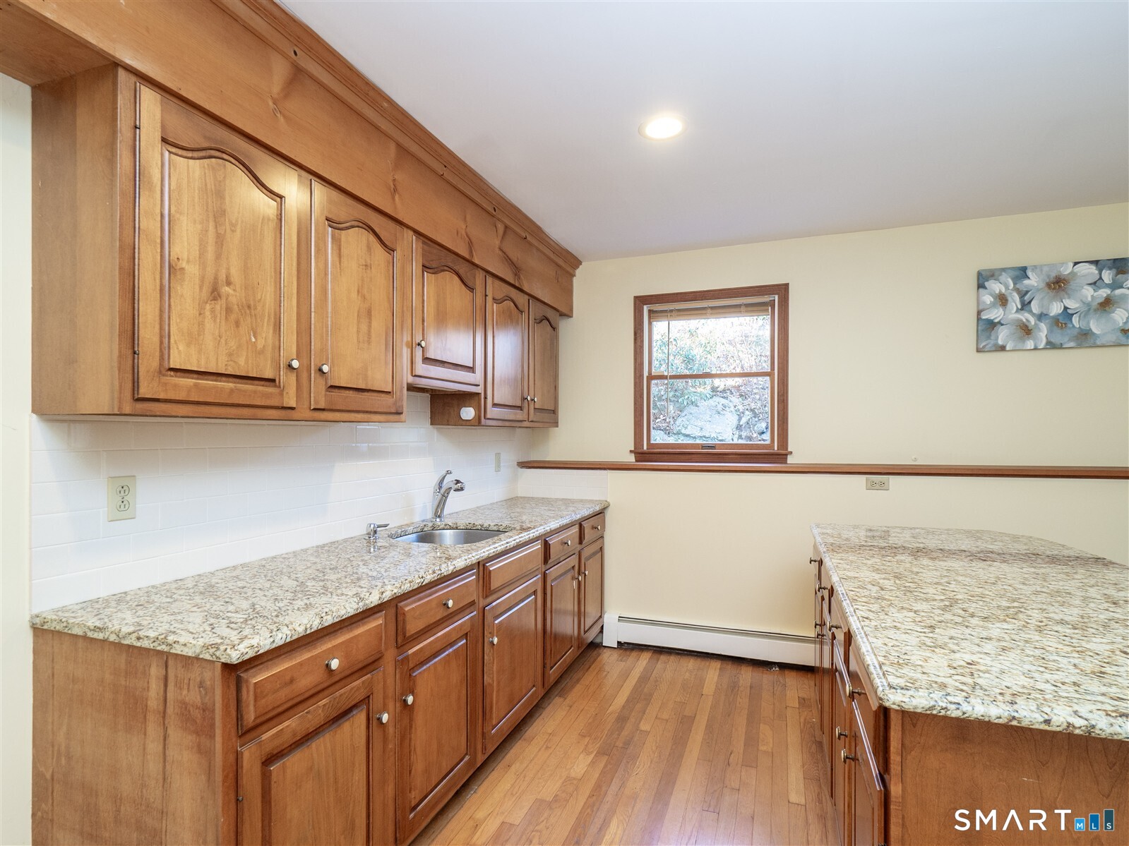 267 Thayer Pond Road Wilton, CT 06897 - Photo 26 of 28 a kitchen with stainless steel appliances granite countertop a sink stove and cabinets