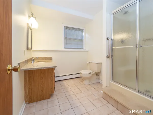 a bathroom with a toilet sink and shower