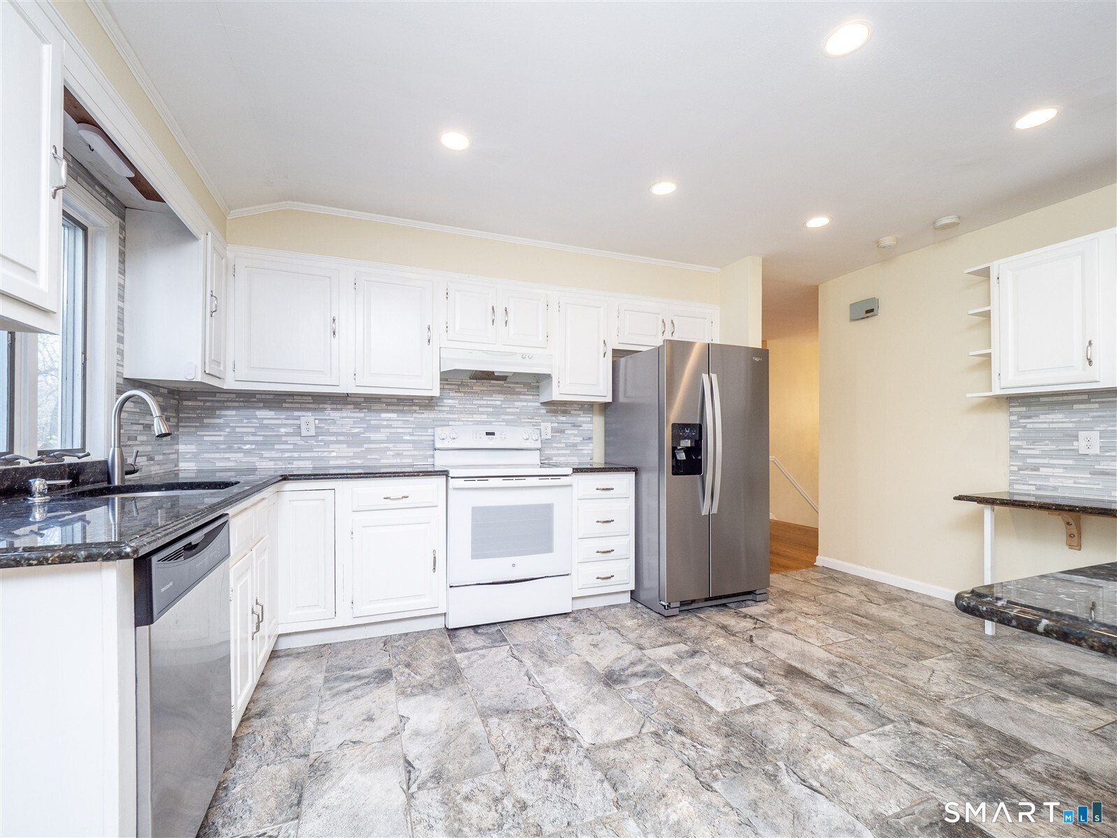 267 Thayer Pond Road Wilton, CT 06897 - Photo 3 of 28 a kitchen with a stove a refrigerator and a sink