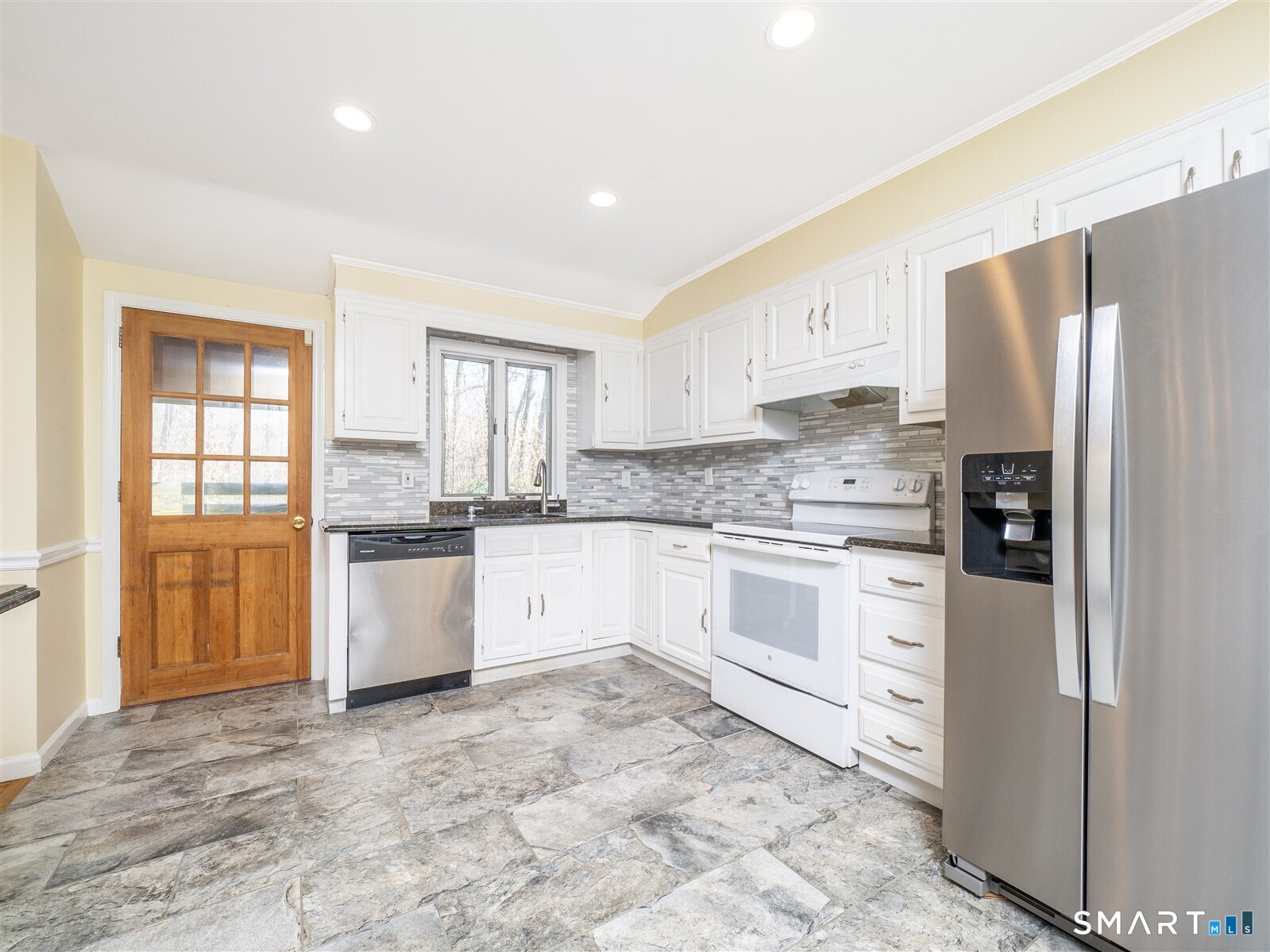 267 Thayer Pond Road Wilton, CT 06897 - Photo 4 of 28 a kitchen with granite countertop a refrigerator sink and cabinets