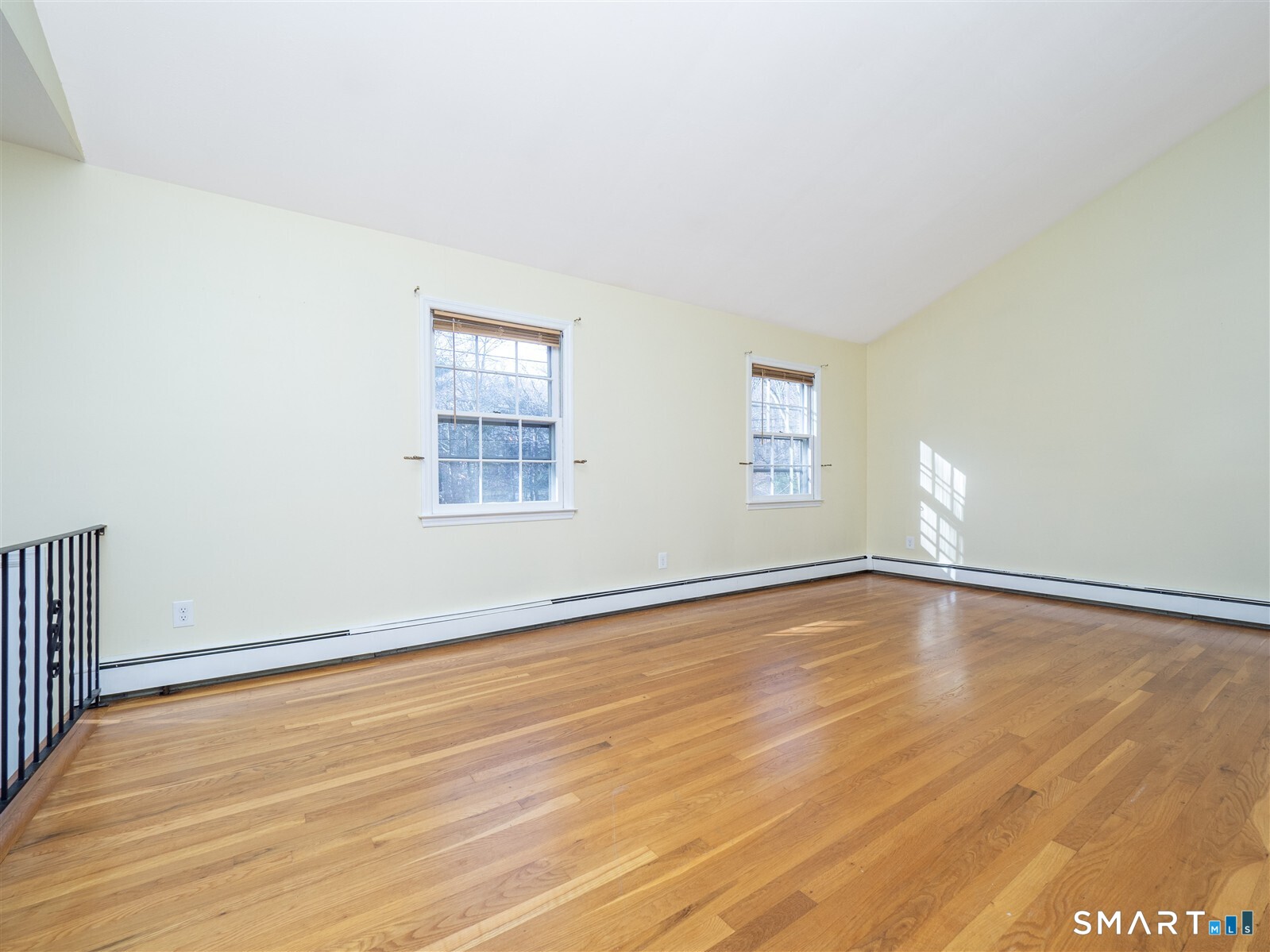 267 Thayer Pond Road Wilton, CT 06897 - Photo 6 of 28 an empty room with wooden floor and window
