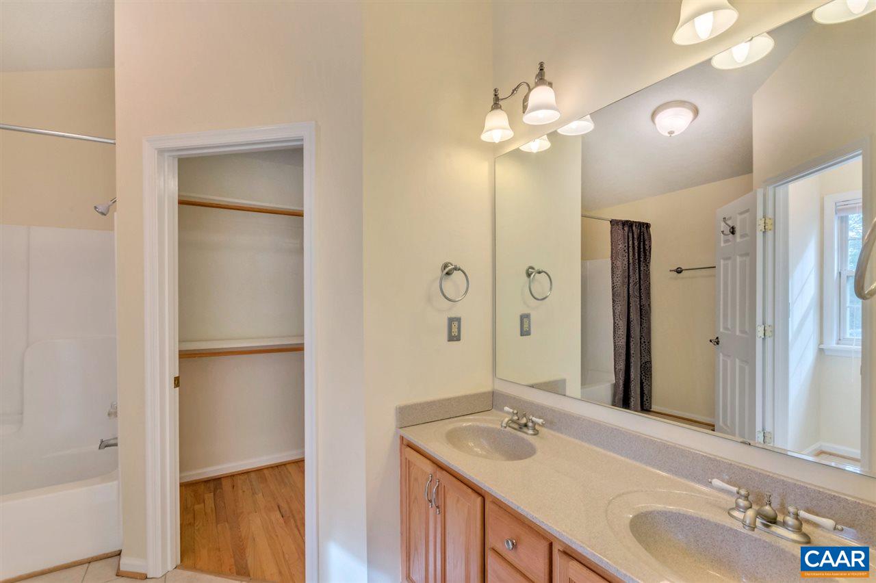 380 Chapel Road Ruckersville, VA 22968 - Photo 11 of 25 a bathroom with a granite countertop sink mirror and a shower