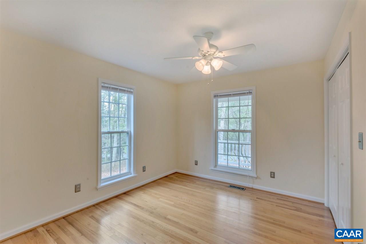 380 Chapel Road Ruckersville, VA 22968 - Photo 14 of 25 an empty room with wooden floor chandelier fan and windows