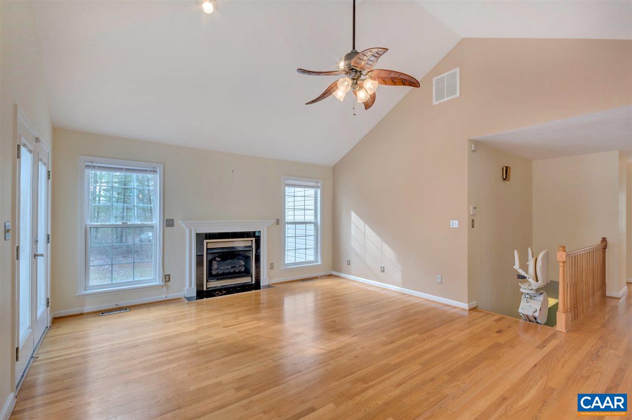 380 Chapel Road Ruckersville, VA 22968 - Photo 4 of 25 a view of a livingroom with a fireplace wooden floor and chandelier