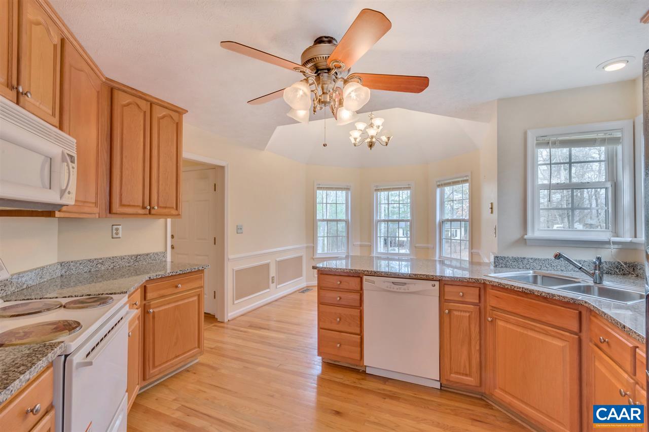 380 Chapel Road Ruckersville, VA 22968 - Photo 6 of 25 a large kitchen with stainless steel appliances granite countertop a stove and a sink with cabinets