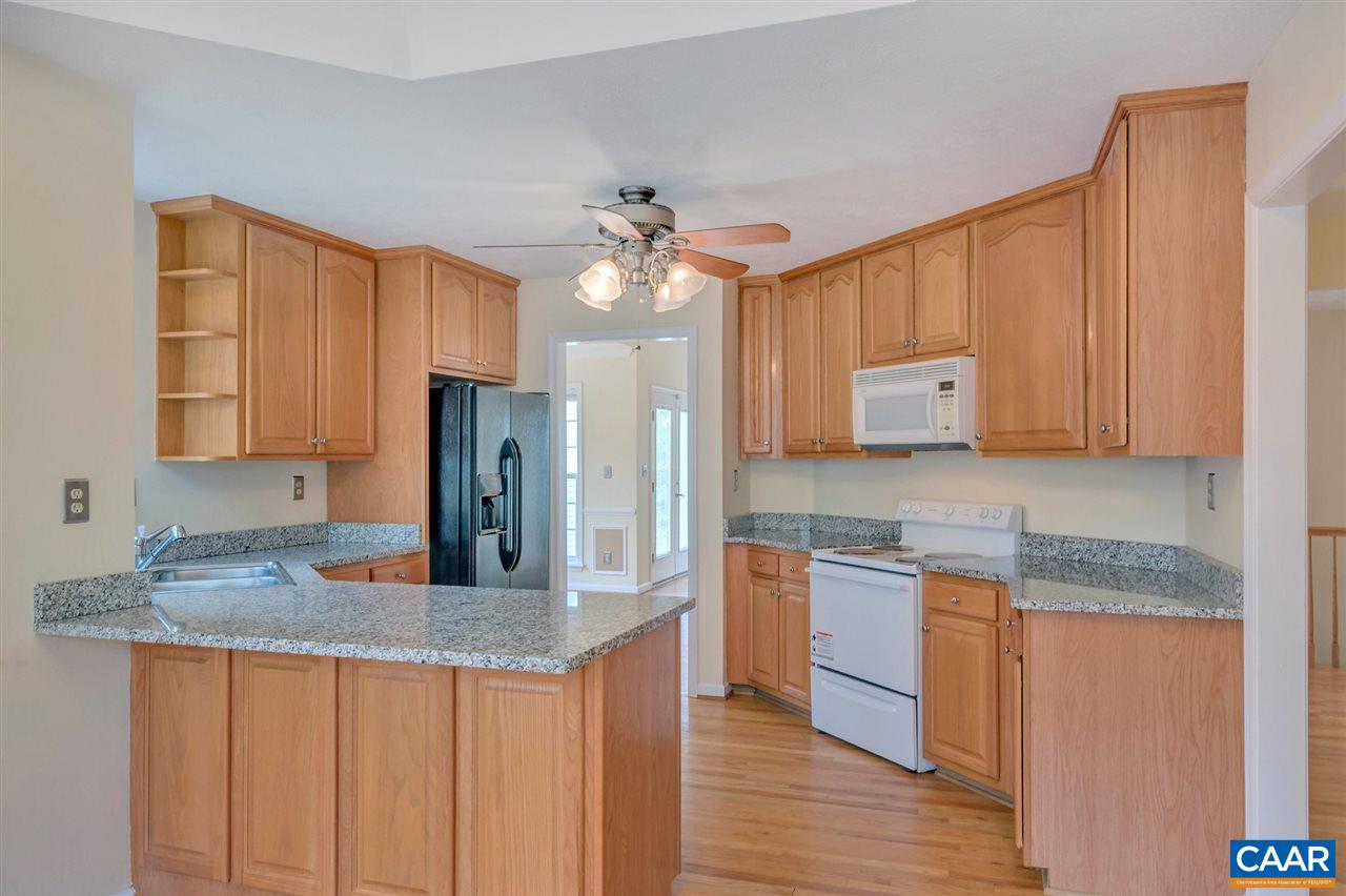 380 Chapel Road Ruckersville, VA 22968 - Photo 8 of 25 a kitchen with stainless steel appliances granite countertop wooden cabinets a sink a stove a dining table and chairs