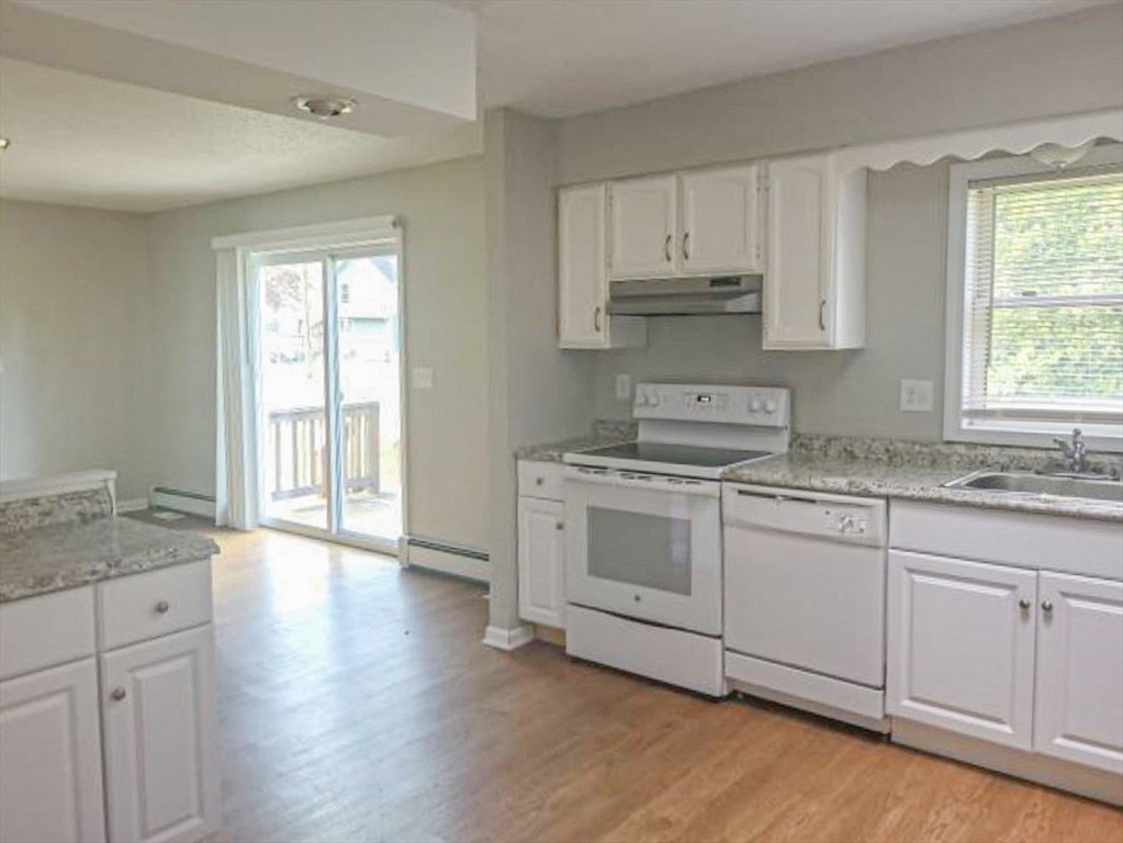 39 Ruggles Street Gilbertville, MA 01031 - Photo 3 of 14 a kitchen with granite countertop white cabinets and white appliances