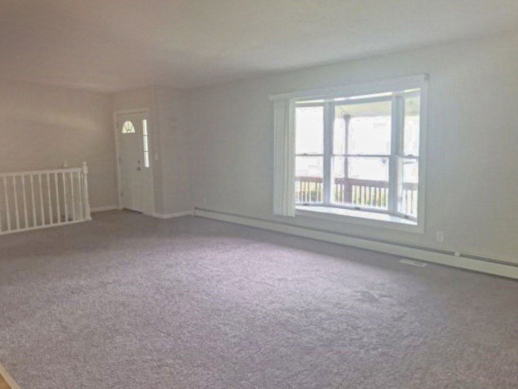39 Ruggles Street Gilbertville, MA 01031 - Photo 5 of 14 an empty room with windows
