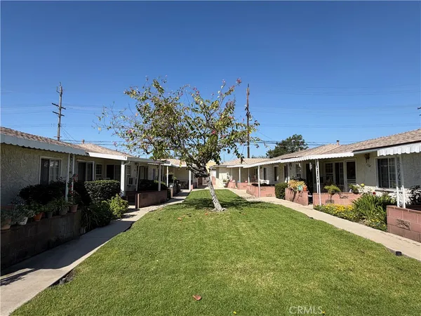 a view of a house with backyard sitting area and garden