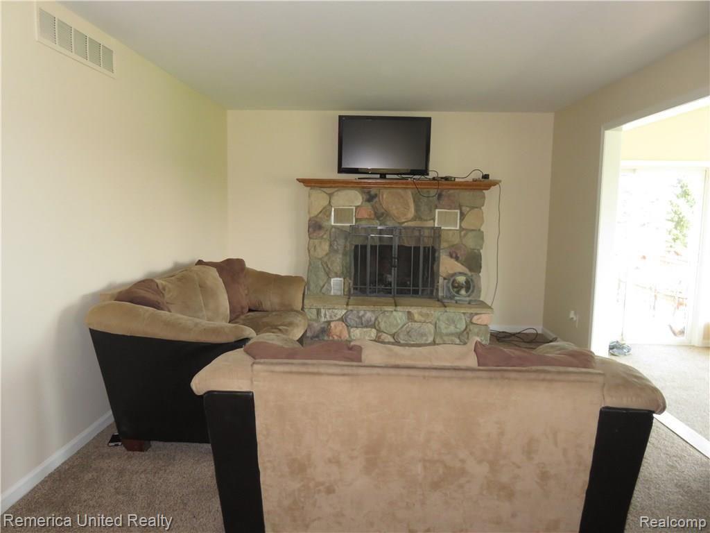 1281 East Jones Road Howell, MI 48855 - Photo 7 of 21 Family Room With Natural Fireplace Leading To The Florida Room & Rear Deck