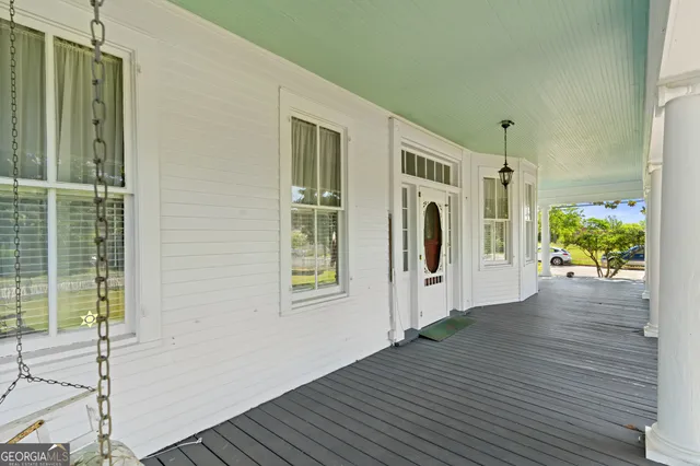 a view of a hallway with wooden floor and a fireplace