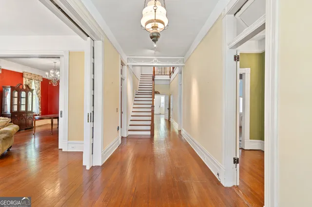 a view of a hallway with wooden floor
