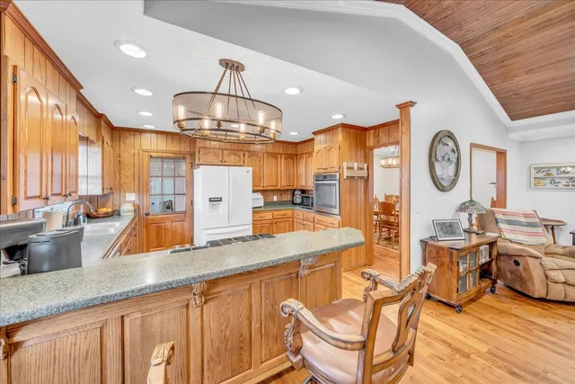 a kitchen with refrigerator a stove a sink and cabinets