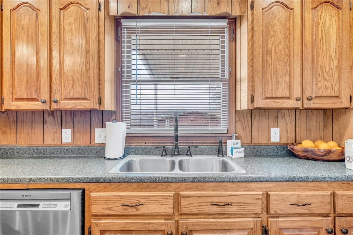 675 Bible Crossing Road Winchester, TN 37398 - Photo 15 of 35 a kitchen with granite countertop wooden cabinets a sink and dishwasher next to a window