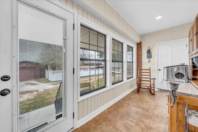 a living room with furniture gym equipment and a large window