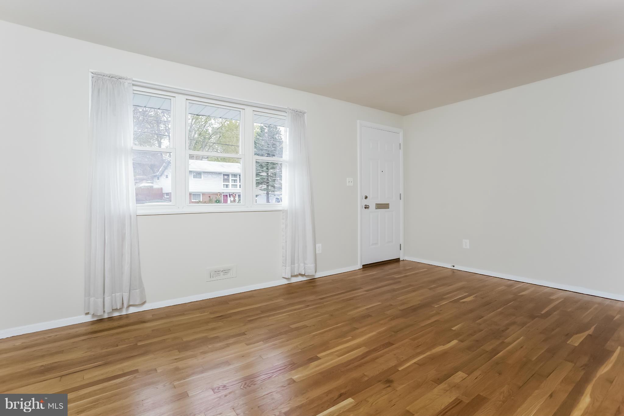 2818 Radius Road Silver Spring, MD 20902 - Photo 5 of 30 a view of an empty room with wooden floor and a window