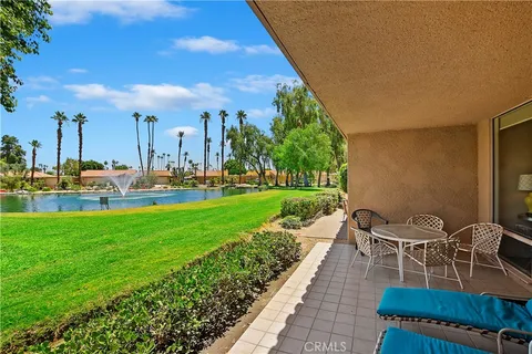 a view of a patio with a table and chairs