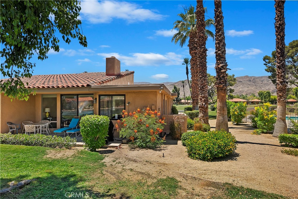 8 Valencia Drive Rancho Mirage, CA 92270 - Photo 13 of 20 a front view of a house with garden
