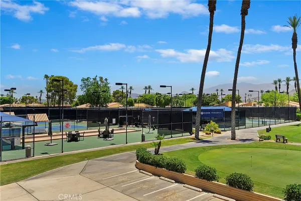 a view of a swimming pool with a lawn chairs and a yard