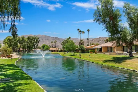 a view of a lake with a house in the background
