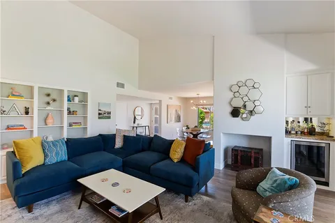 a living room with furniture a fireplace and a chandelier